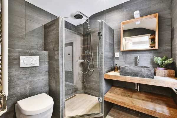 Weathered antique hardwood floor mirror in bathroom