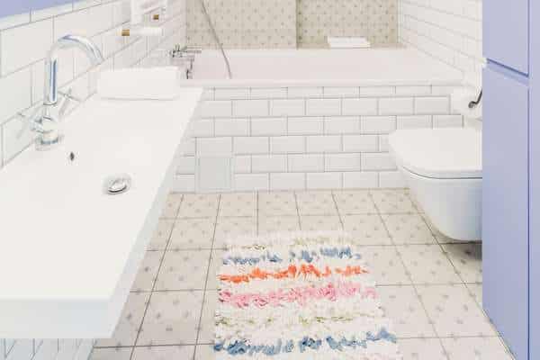 Get a cushy surface with a fluffy mat in bathroom