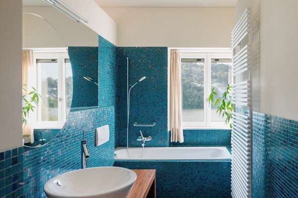 Incorporate a whimsical mood with blue wallpaper and grey panelling in bathroom