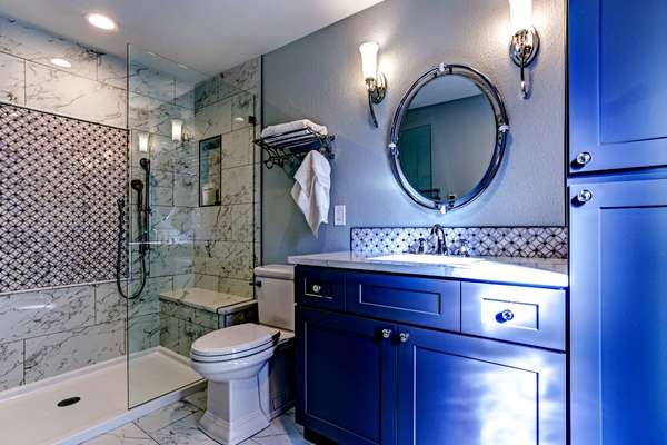 Open the shower with blue tiles in bathroom